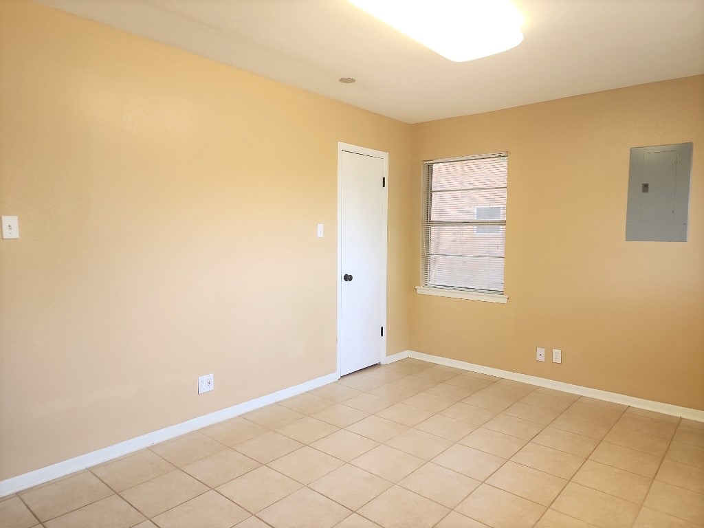 807 Country Club Road Georgetown, TX 78628 - Photo 29 of 31 Unfurnished room with electric panel and light tile patterned flooring