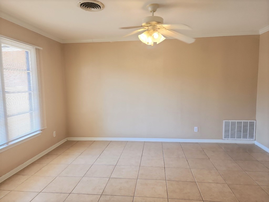 807 Country Club Road Georgetown, TX 78628 - Photo 3 of 31 Spare room with light tile patterned flooring, ornamental molding, and ceiling fan