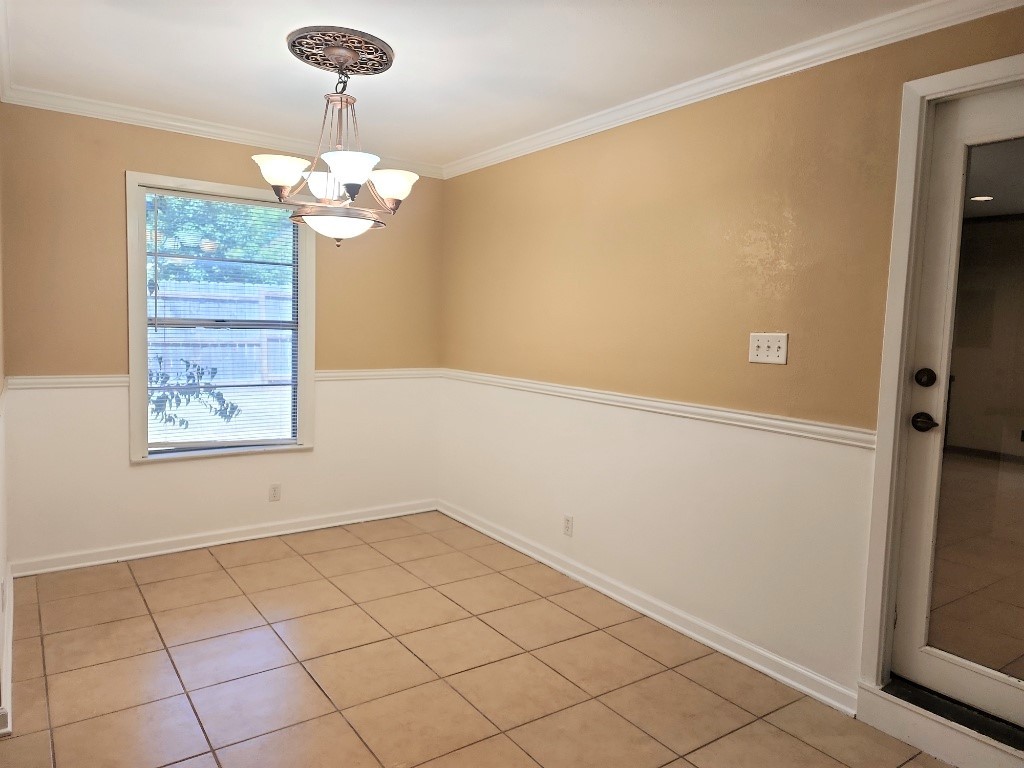 807 Country Club Road Georgetown, TX 78628 - Photo 8 of 31 Unfurnished dining area featuring ornamental molding, light tile patterned floors, and a chandelier