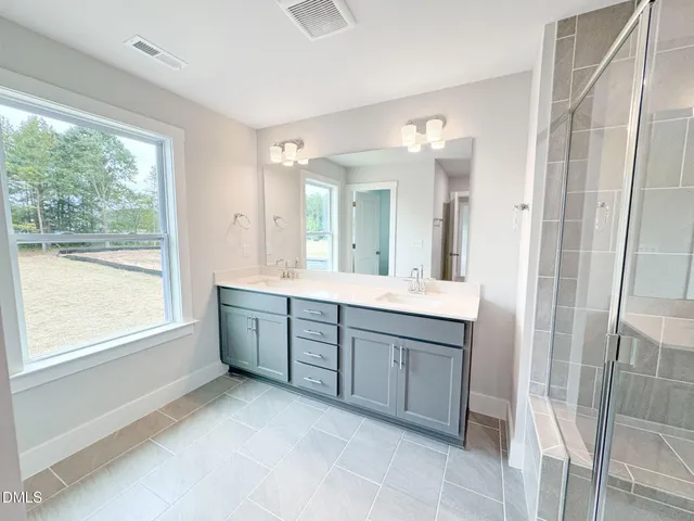 a view of a hallway with wooden floor and closet
