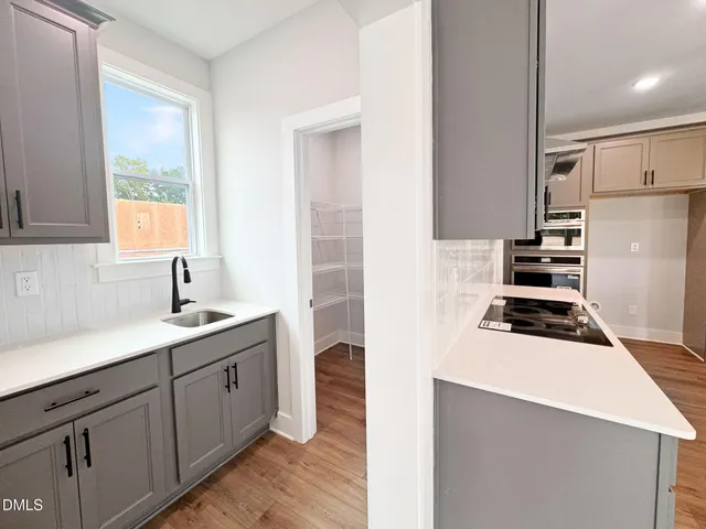 a kitchen with stainless steel appliances kitchen island sink refrigerator and fireplace