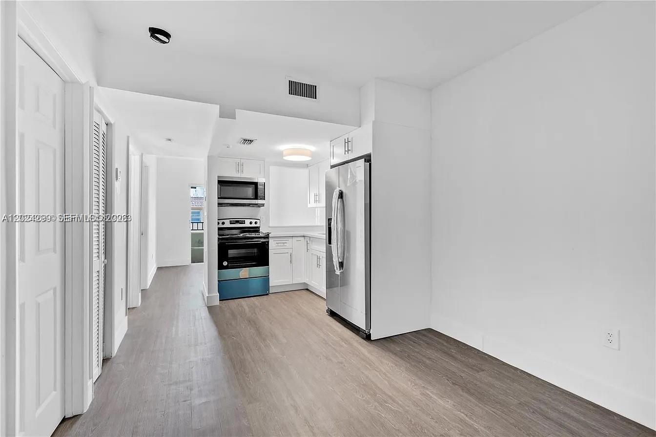 1351 Southwest 4th Street, Unit 8 Miami, FL 33135 - Photo 1 of 11 a view of a kitchen with refrigerator and a stove