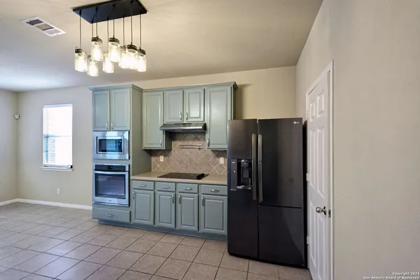a kitchen with stainless steel appliances a refrigerator and a sink
