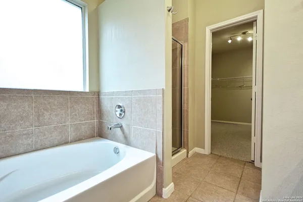 a bathroom with a tub and shower