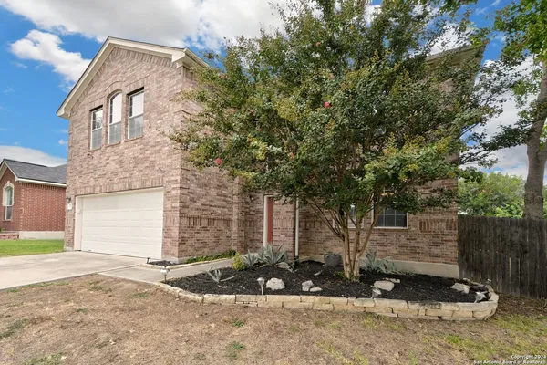 front view of a house with a tree