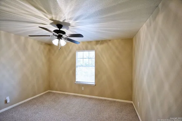 a view of a room with a ceiling fan