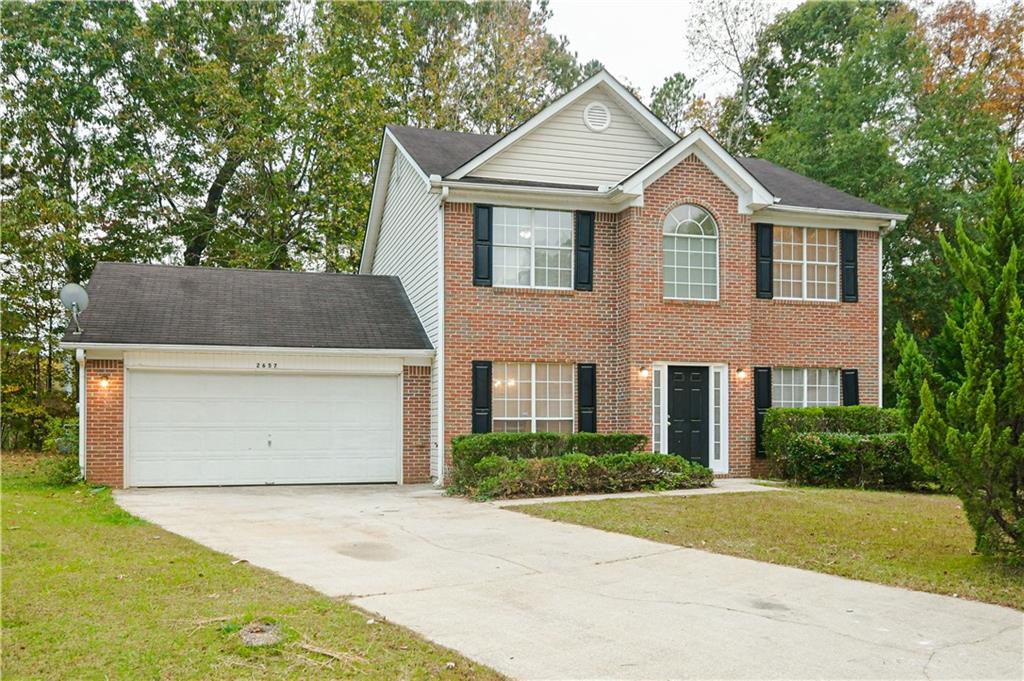 2657 River Summit Lane Decatur, GA 30034 - Photo 1 of 1 a front view of a house with a yard and garage