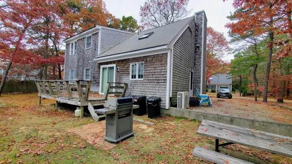 a backyard of a house with barbeque oven and outdoor seating