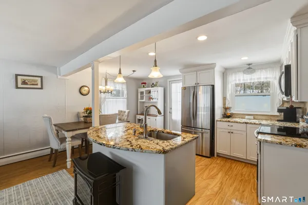 a kitchen with refrigerator and cabinets