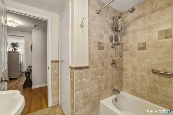 a bathroom with a tub a sink and a shower