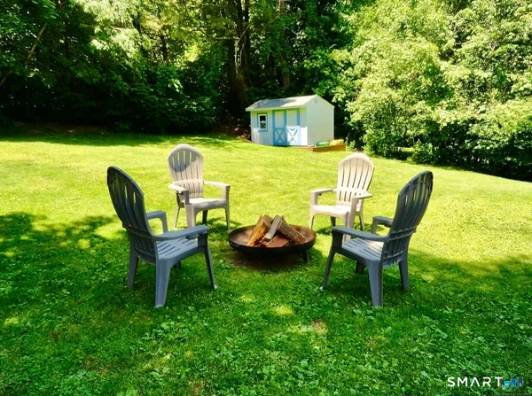 a view of a chairs in backyard of the house