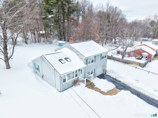 a view of a house with a yard and trees