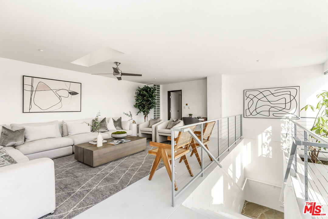 7401 Studio Road West Hills, CA 91304 - Photo 12 of 18 a living room with furniture and wooden floor