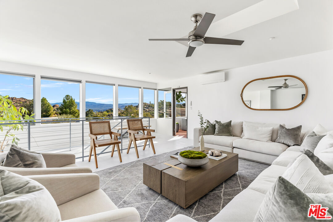 7401 Studio Road West Hills, CA 91304 - Photo 13 of 18 a living room with furniture and a large window