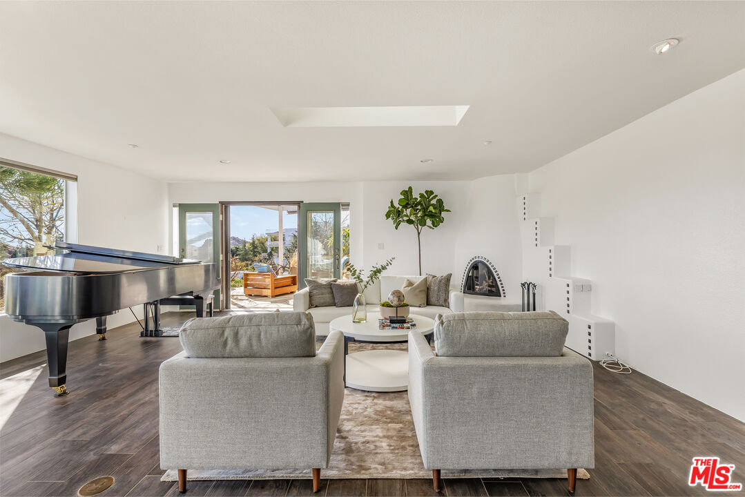 7401 Studio Road West Hills, CA 91304 - Photo 2 of 18 a living room with fireplace furniture and wooden floor