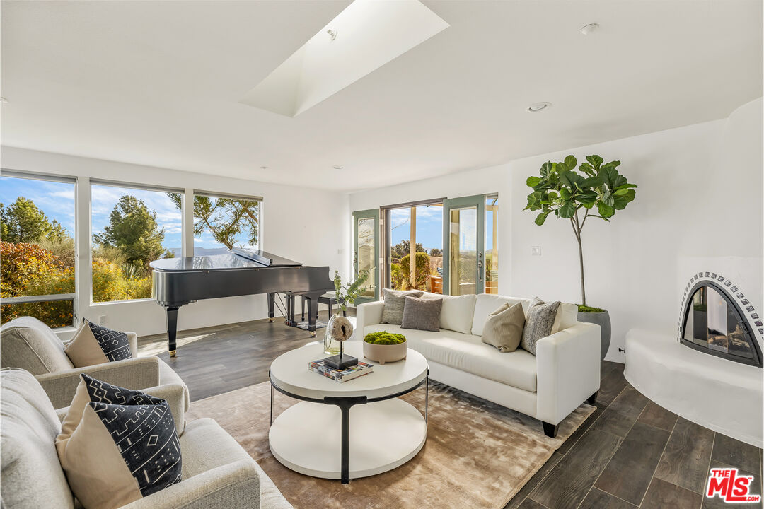 7401 Studio Road West Hills, CA 91304 - Photo 3 of 18 a living room with furniture and a large window