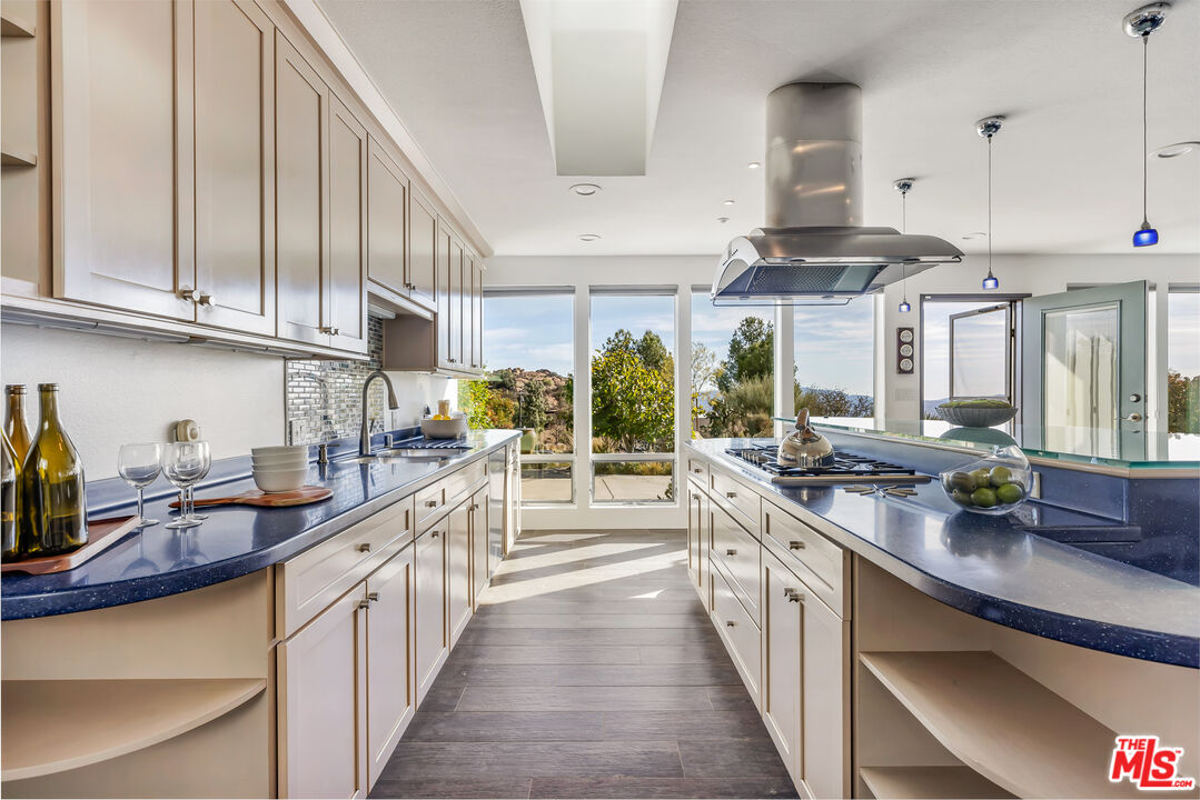 7401 Studio Road West Hills, CA 91304 - Photo 5 of 18 a kitchen with lots of counter space and wooden floor
