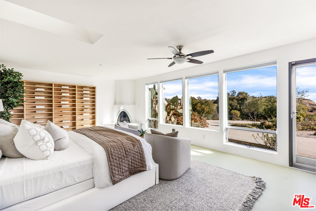 7401 Studio Road West Hills, CA 91304 - Photo 7 of 18 a spacious bedroom with a large bed and a large window
