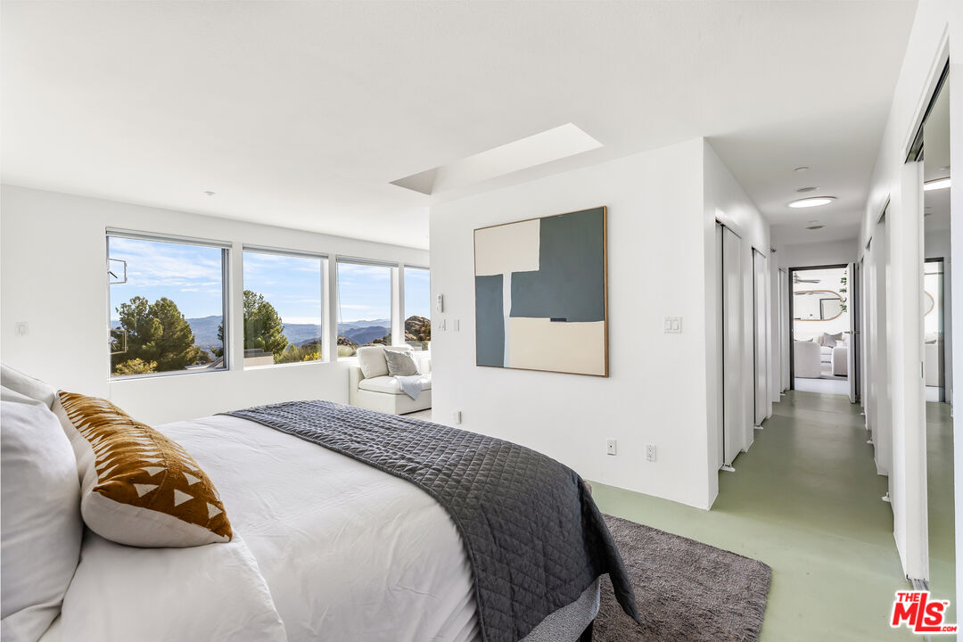 7401 Studio Road West Hills, CA 91304 - Photo 9 of 18 a bedroom with a bed and glass walk in closet