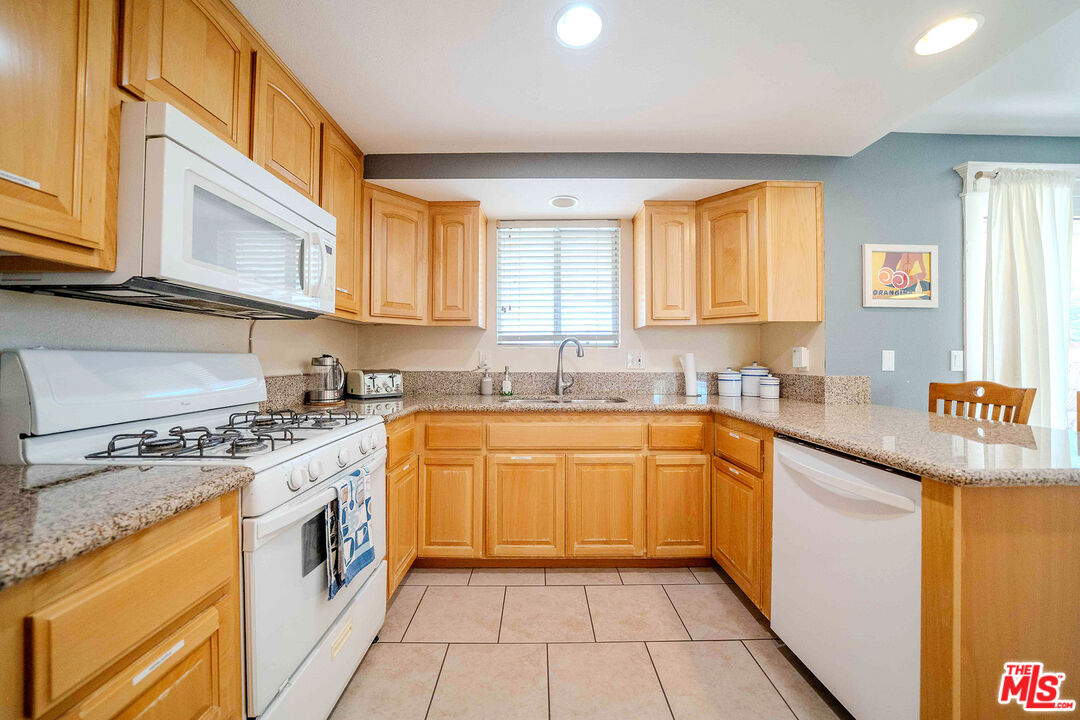 9524 Santa Cruz Road Desert Hot Springs, CA 92240 - Photo 15 of 53 a kitchen with stainless steel appliances granite countertop a sink and cabinets