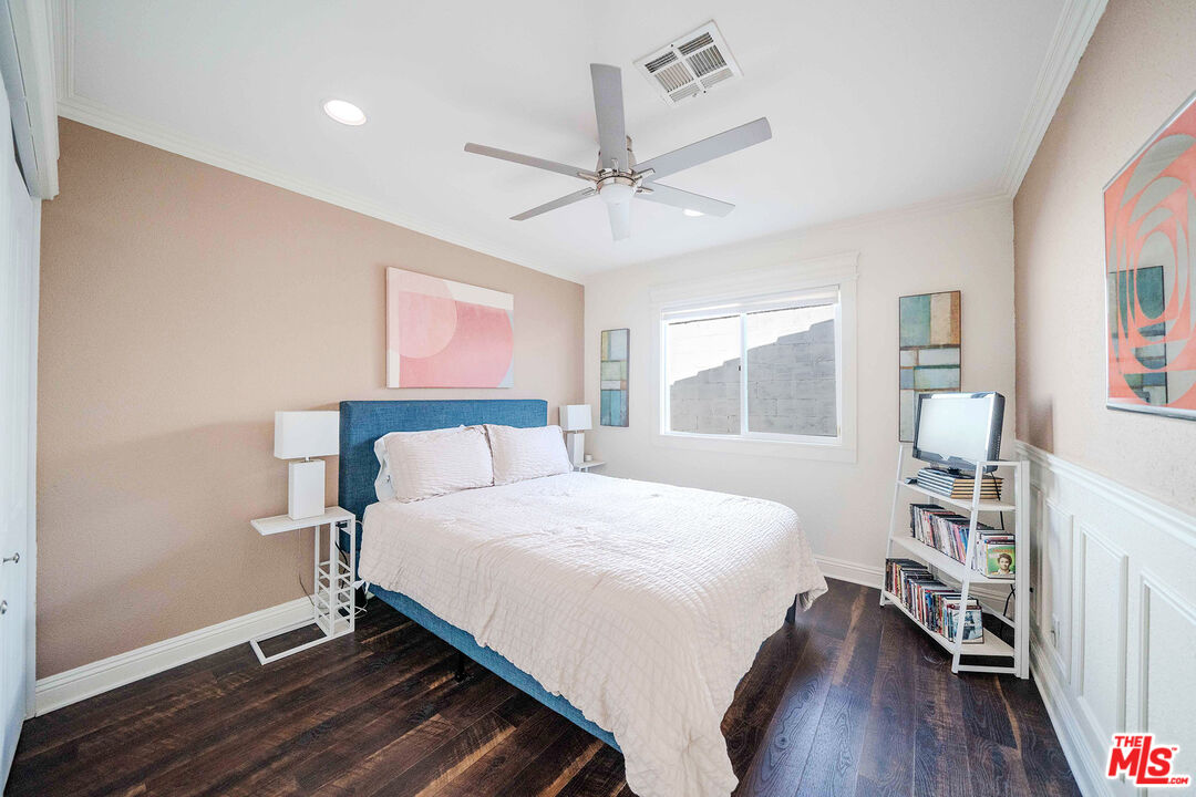 9524 Santa Cruz Road Desert Hot Springs, CA 92240 - Photo 16 of 53 a bedroom with a large bed wooden floor and window