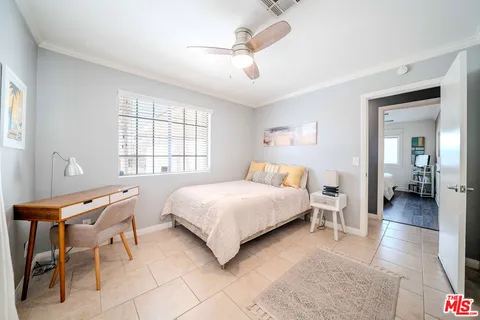 a bedroom with a bed and glass door