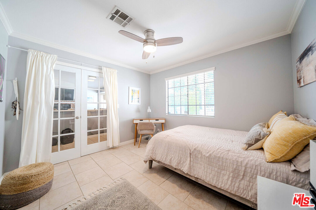 9524 Santa Cruz Road Desert Hot Springs, CA 92240 - Photo 20 of 53 a bedroom with a bed and glass door