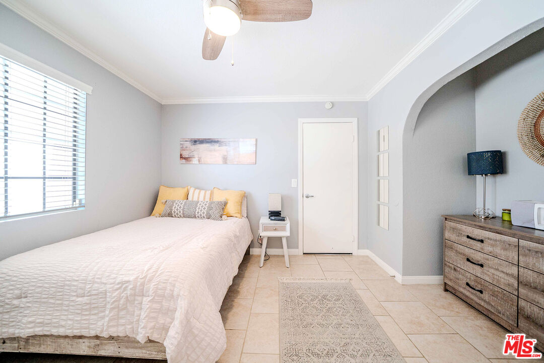 9524 Santa Cruz Road Desert Hot Springs, CA 92240 - Photo 21 of 53 a bedroom with a bed and a flat screen tv