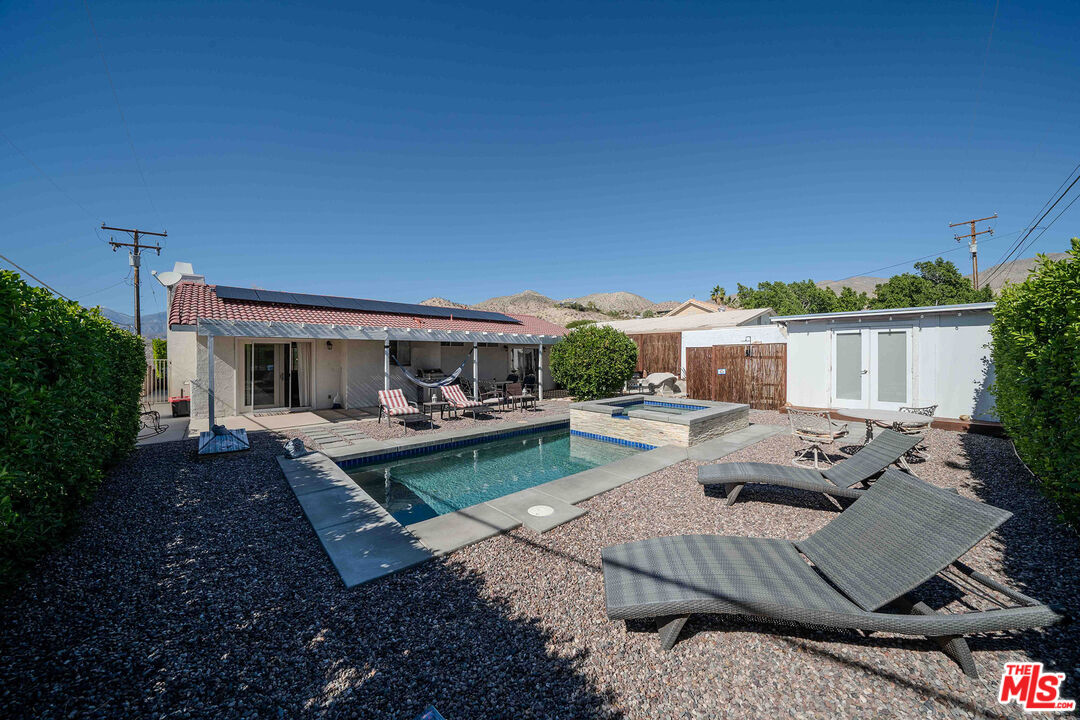 9524 Santa Cruz Road Desert Hot Springs, CA 92240 - Photo 29 of 53 a view of a house with backyard and sitting area