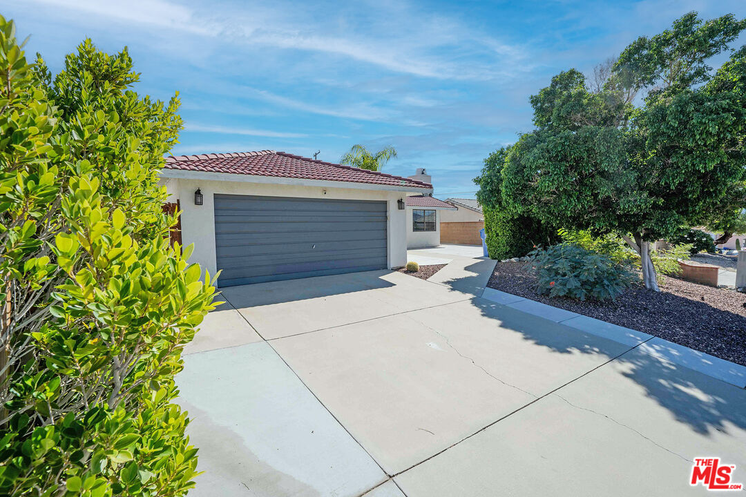 9524 Santa Cruz Road Desert Hot Springs, CA 92240 - Photo 3 of 53 a front view of a house with a garden
