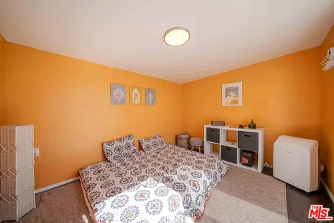 a bedroom with a bed and a couch