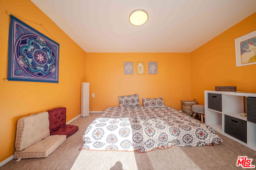 9524 Santa Cruz Road Desert Hot Springs, CA 92240 - Photo 32 of 53 a bedroom with a bed and a couch