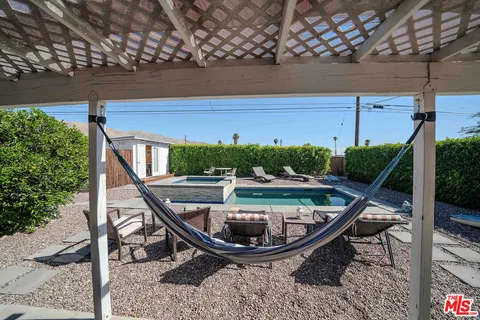a balcony with table and chairs