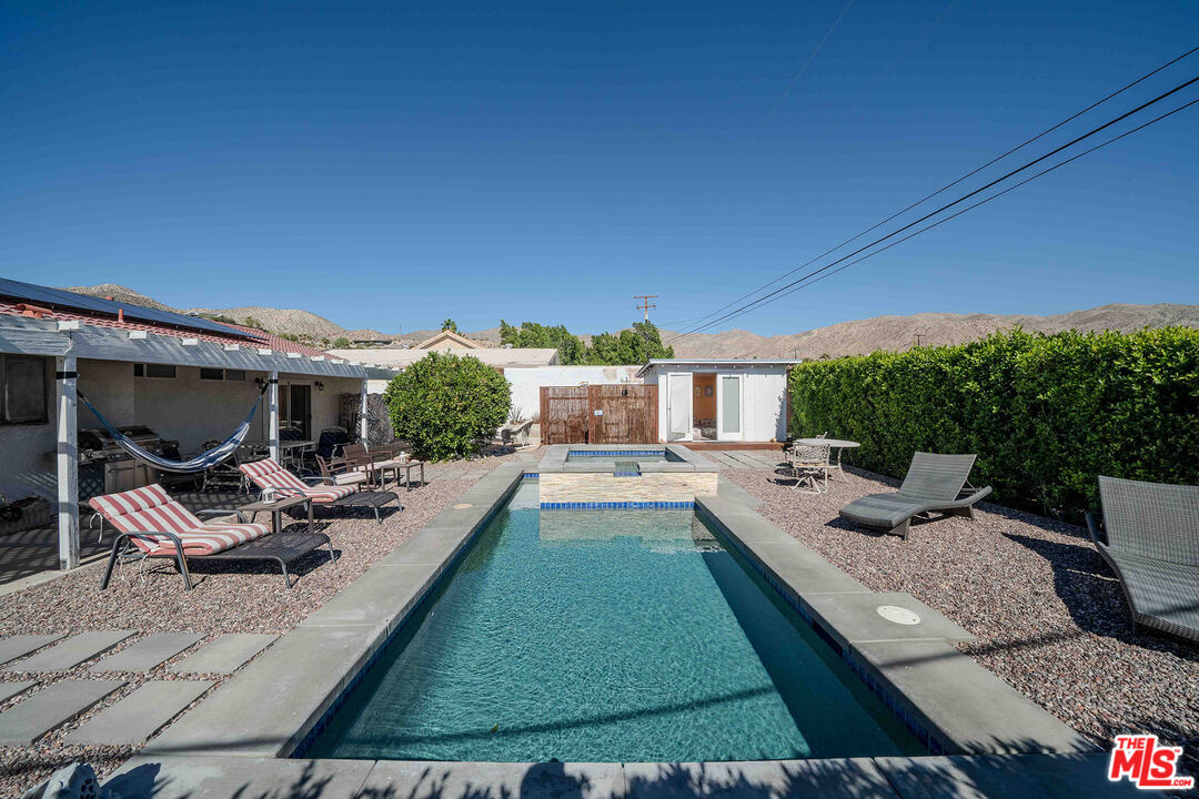 9524 Santa Cruz Road Desert Hot Springs, CA 92240 - Photo 39 of 53 a view of a house with backyard porch and outdoor seating