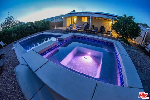 an aerial view of a house with swimming pool
