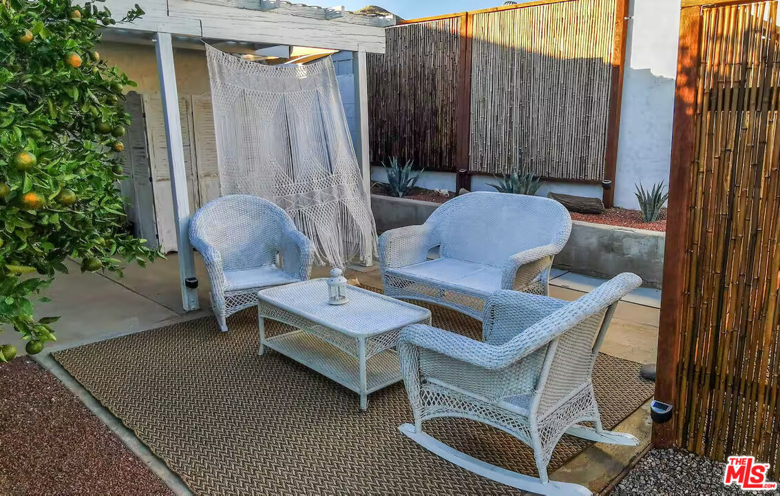 9524 Santa Cruz Road Desert Hot Springs, CA 92240 - Photo 48 of 53 a backyard of a house with table and chairs