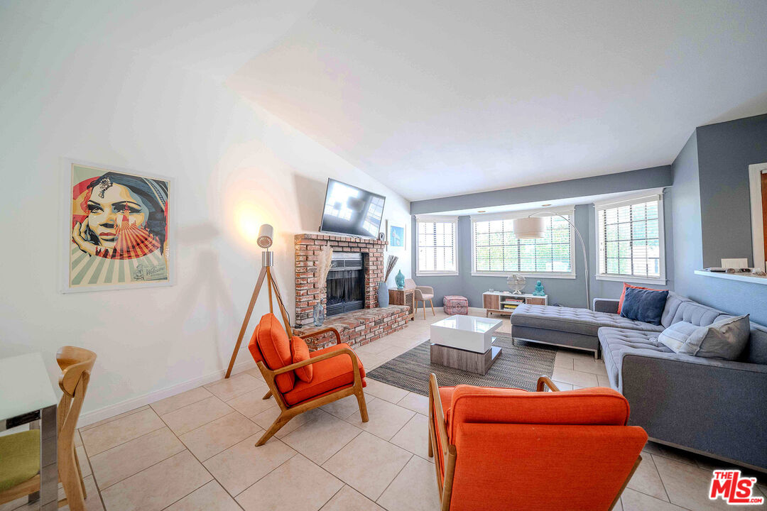 9524 Santa Cruz Road Desert Hot Springs, CA 92240 - Photo 8 of 53 a living room with furniture a fireplace and a large window