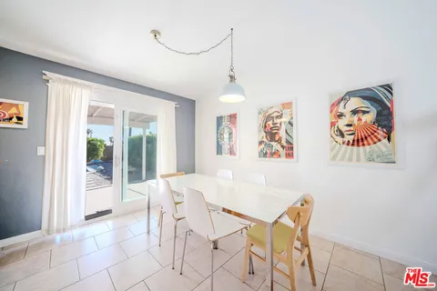 a dining room with furniture and a kitchen view
