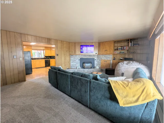 a living room with furniture and a kitchen