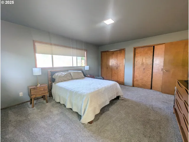 a spacious bedroom with a bed and a window