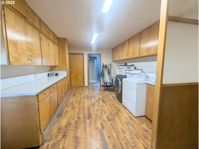 a view of a kitchen with a sink and wooden floor
