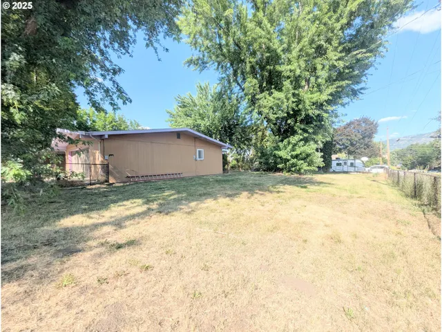 a view of a house with a yard and sitting area