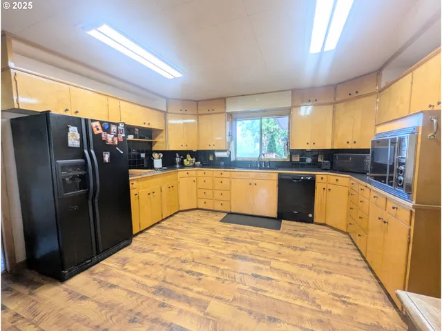 a kitchen with stainless steel appliances granite countertop a refrigerator a sink a stove and island