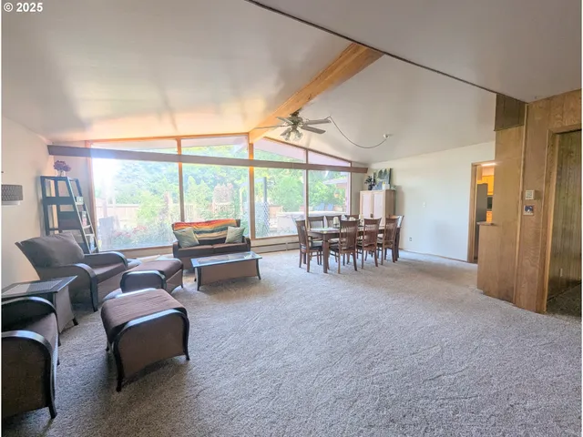 a living room with furniture and floor to ceiling windows