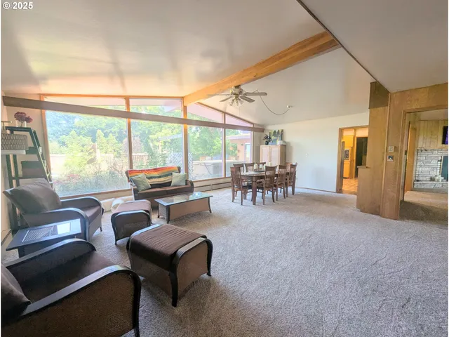 a work room with furniture and large windows