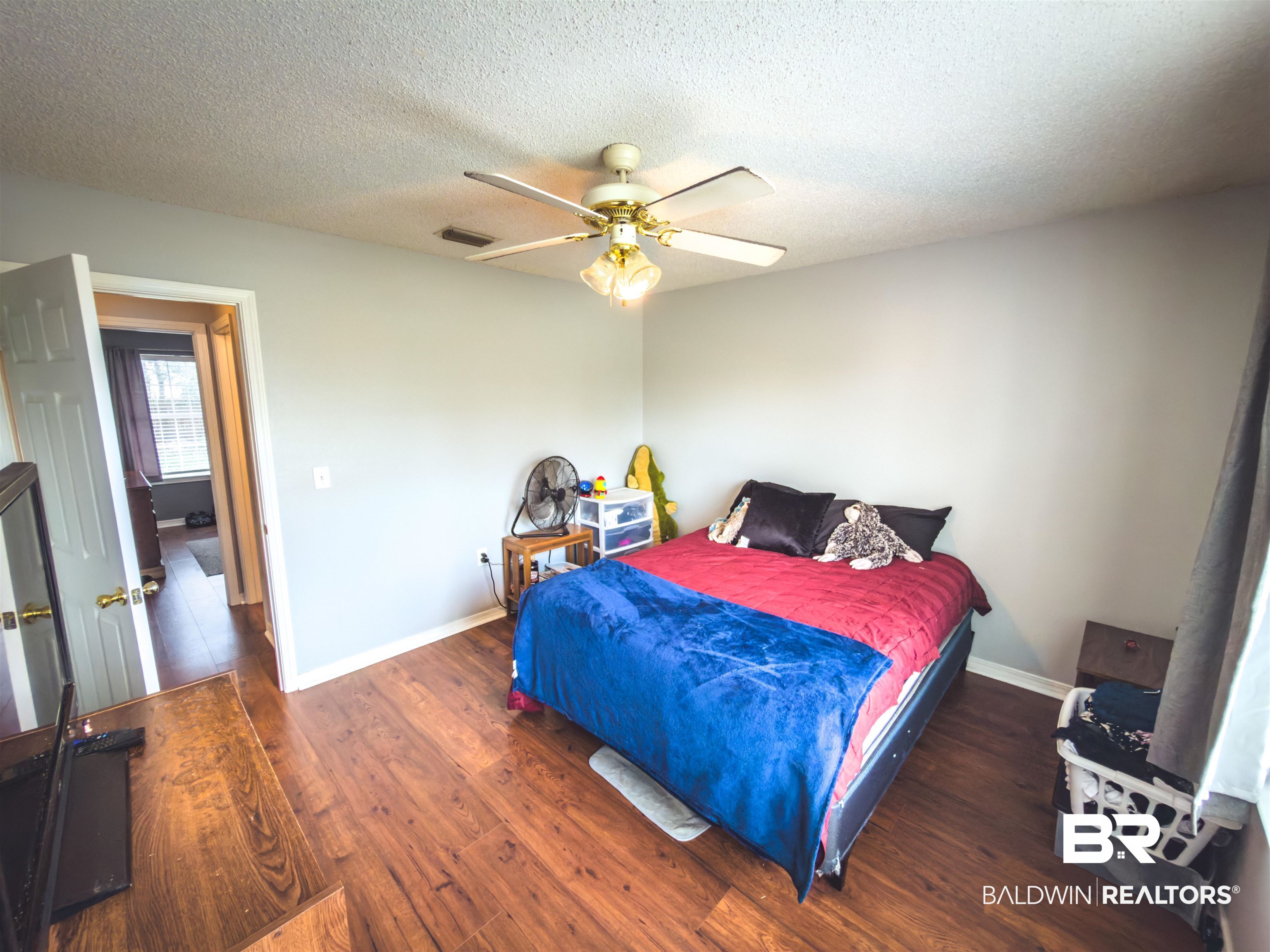 129 Pennbrooke Loop Foley, AL 36535 - Photo 12 of 44 Bedroom with a textured ceiling, hardwood / wood-style floors, and a ceiling fan