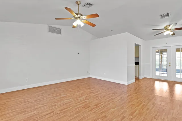 wooden floor in an empty room with a window