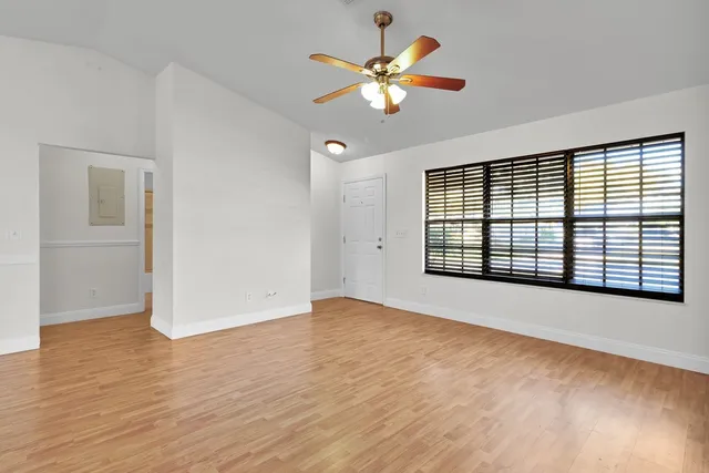 wooden floor in an empty room with a window