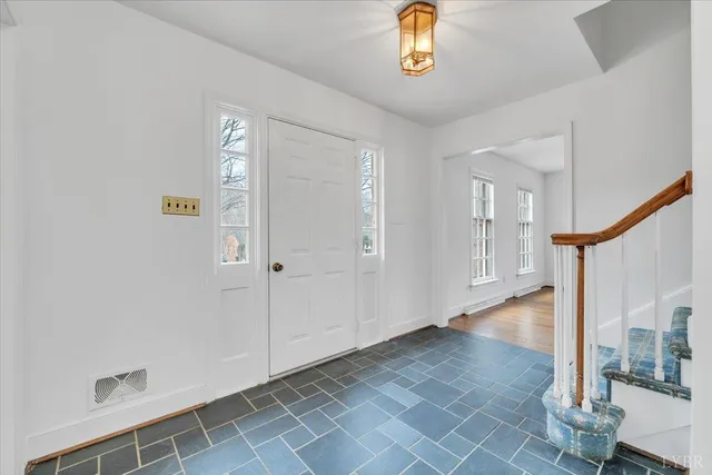 a view of an entryway with wooden floor
