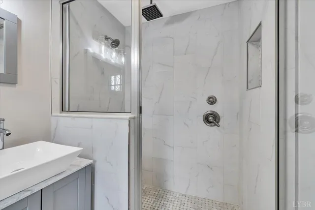 a bathroom with a toilet a sink a vanity and windows